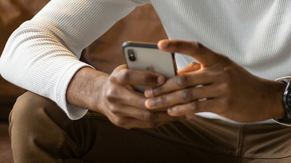 Photo by Monstera: https://www.pexels.com/photo/positive-black-man-using-smartphone-while-sitting-on-sofa-5997313/