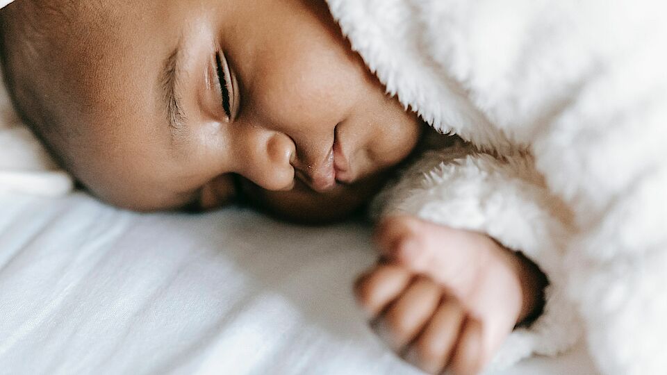 Photo by William  Fortunato : https://www.pexels.com/photo/sleeping-newborn-black-baby-lying-on-bed-6392895/